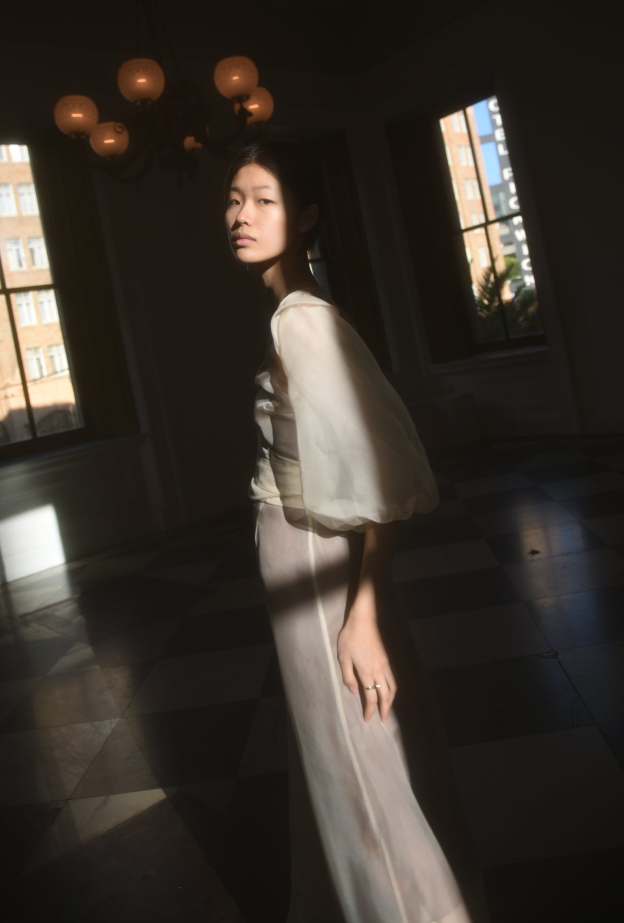 Side view of the ivory silk organza Kamperett Loretta Midi wedding dress with self-belt at the natural waist.