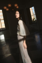 Side view of the ivory silk organza Kamperett Loretta Midi wedding dress with self-belt at the natural waist.