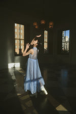 Editorial image of the cornflower silk organza Kamperett Mae Dress.