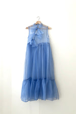 Flat image of the Kamperett Mae Dress showing the true cornflower color of the silk organza fabric.