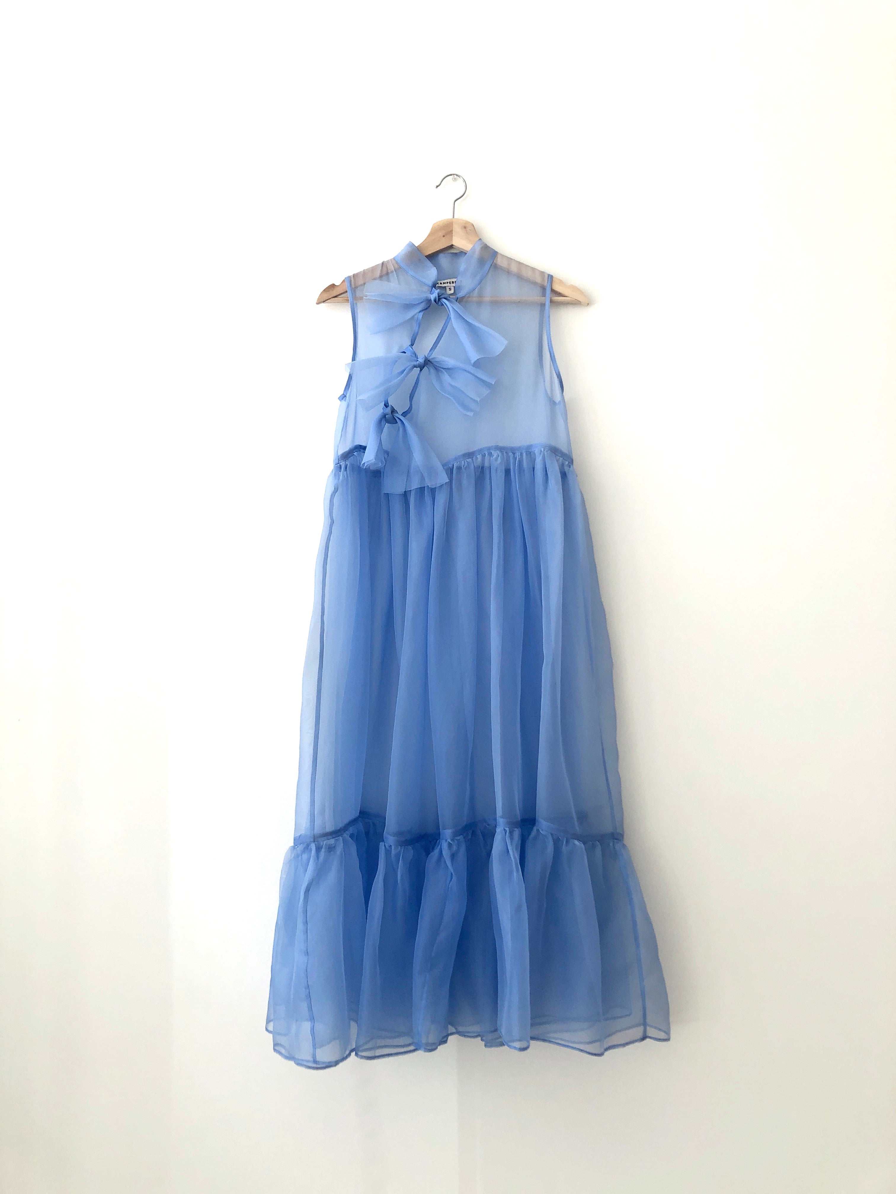 Flat image of the Kamperett Mae Dress showing the true cornflower color of the silk organza fabric.