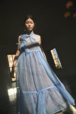 Side view of the cornflower silk organza Kamperett Mae Dress showing the full skirt and gathered hem ruffle.
