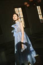 Detail of the qipao-inspired tie front closure on the cornflower silk organza Kamperett Mae Dress.