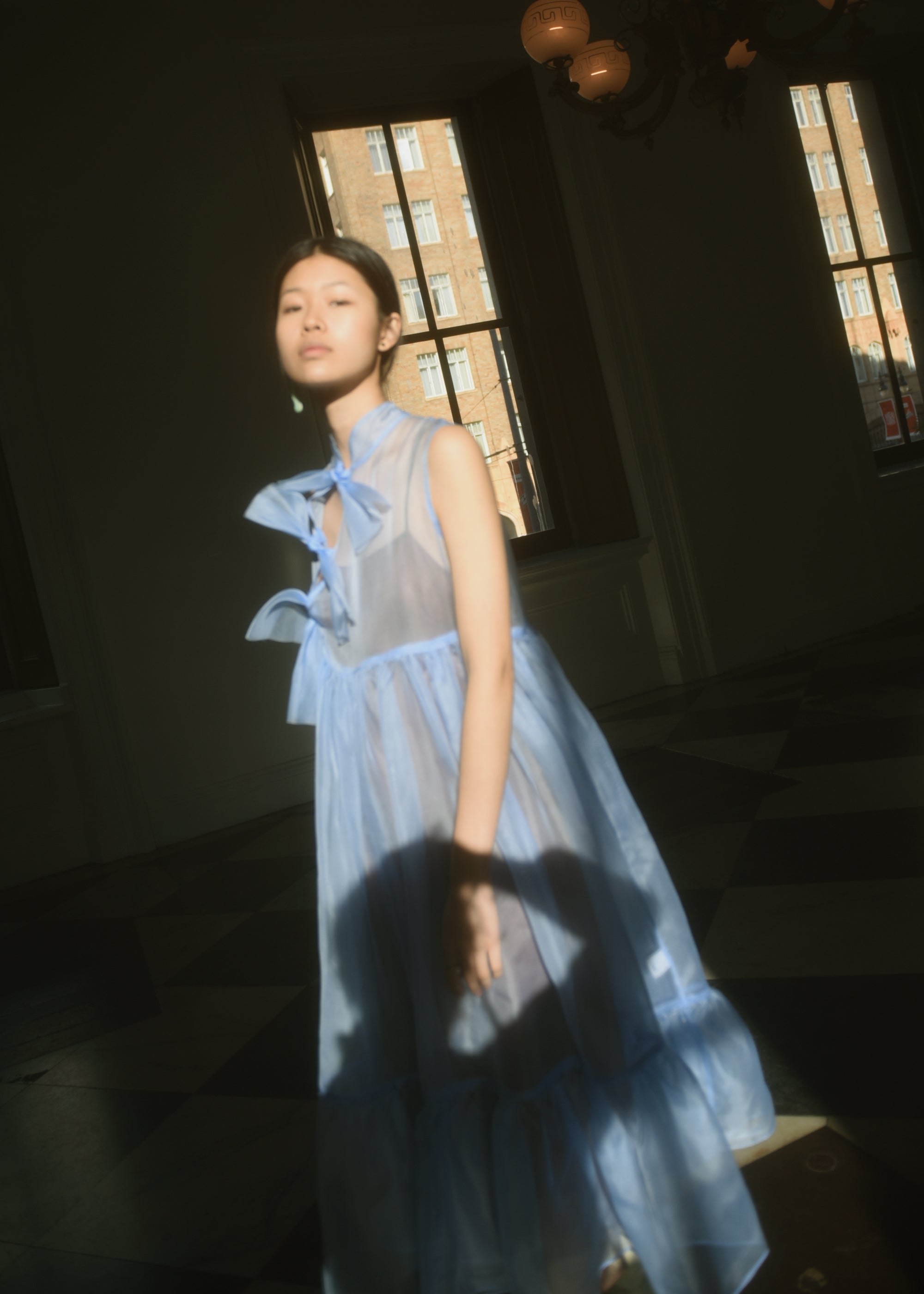 Detail of the qipao-inspired tie front closure on the cornflower silk organza Kamperett Mae Dress.