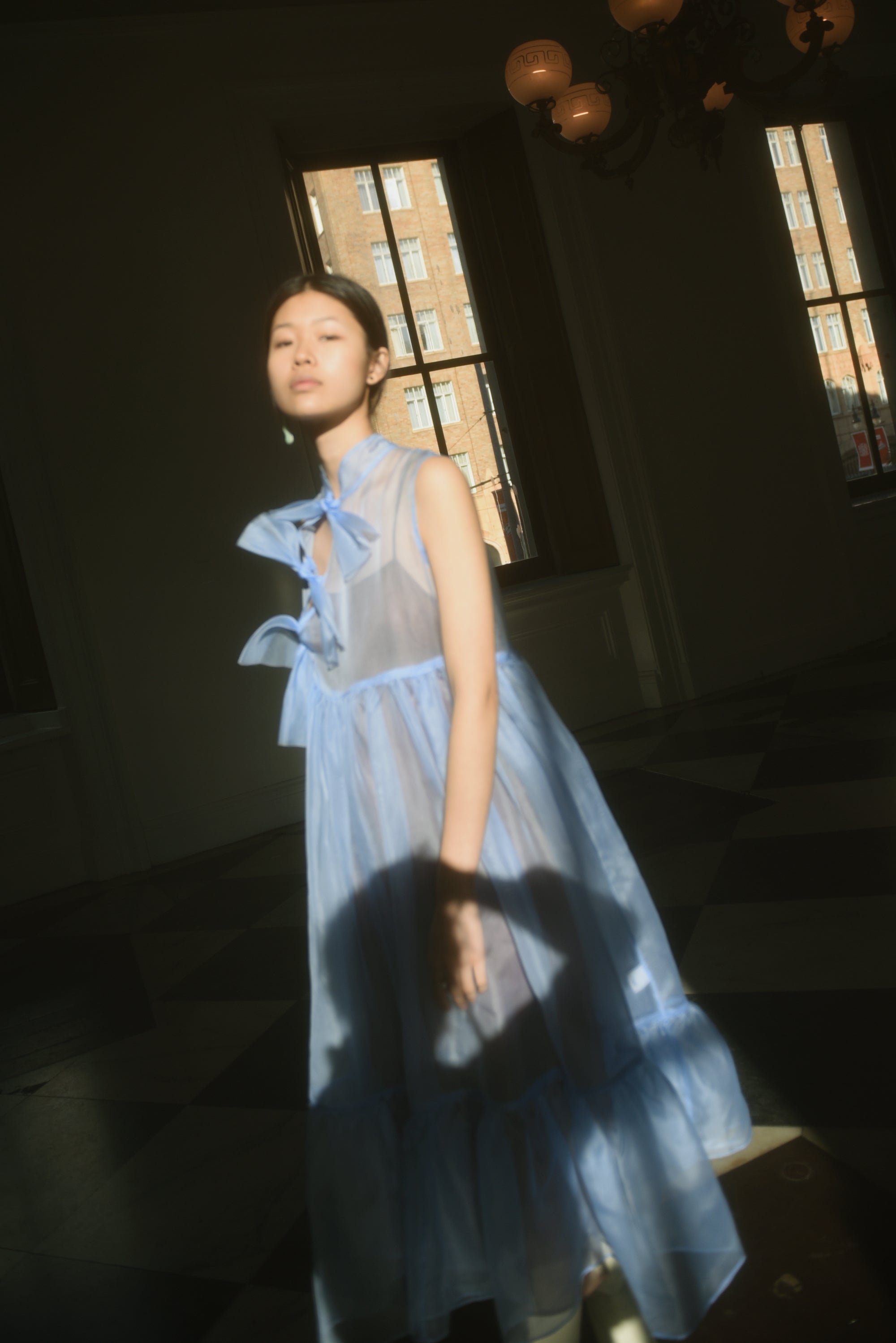 Detail of the qipao-inspired tie front closure on the cornflower silk organza Kamperett Mae Dress.