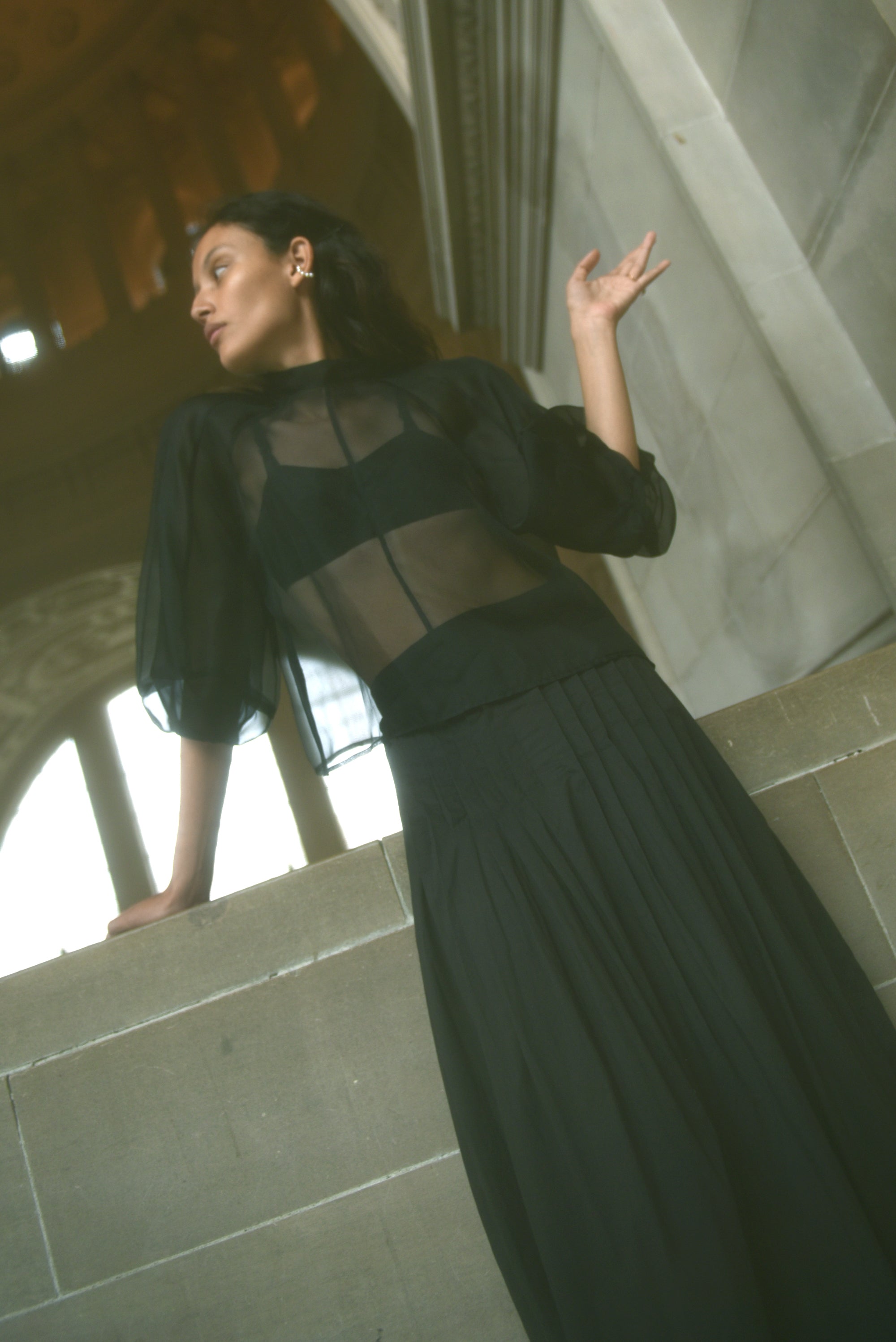 Back view of the black silk organza Kamperett Meiere Blouse with two fabric-covered button closure at back neck.