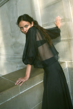 Side view of the black silk organza Kamperett Meiere Blouse showing the intricately seamed sleeves.