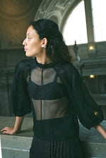 Editorial image of the ivory silk organza Kamperett Meiere Blouse with architectural sleeves.