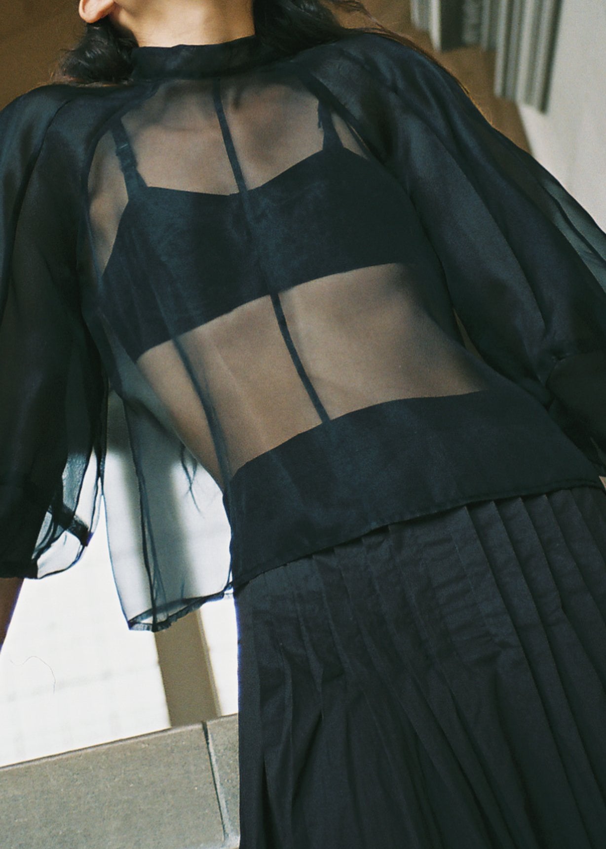 Side view of the ivory silk organza Kamperett Meiere Blouse with boxy fit bodice.