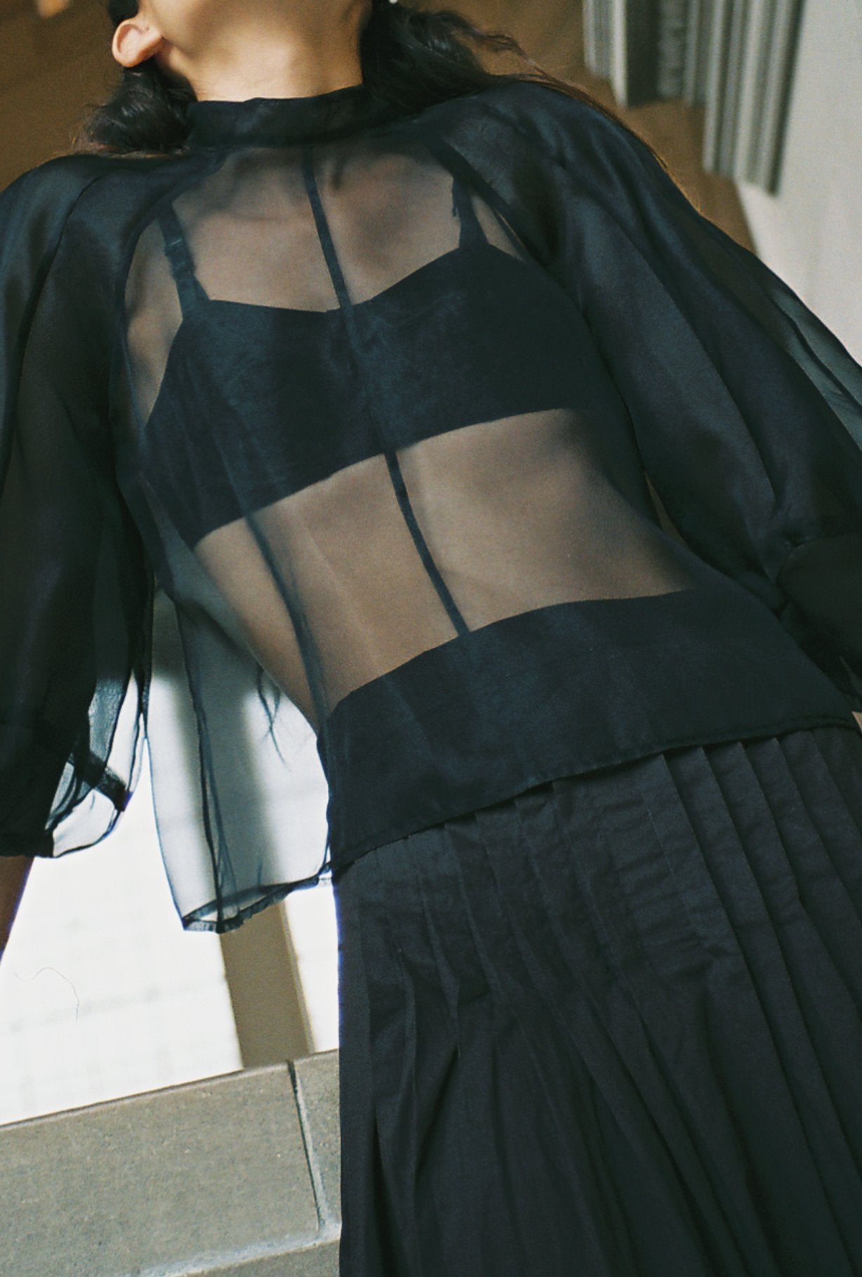 Side view of the ivory silk organza Kamperett Meiere Blouse with boxy fit bodice.