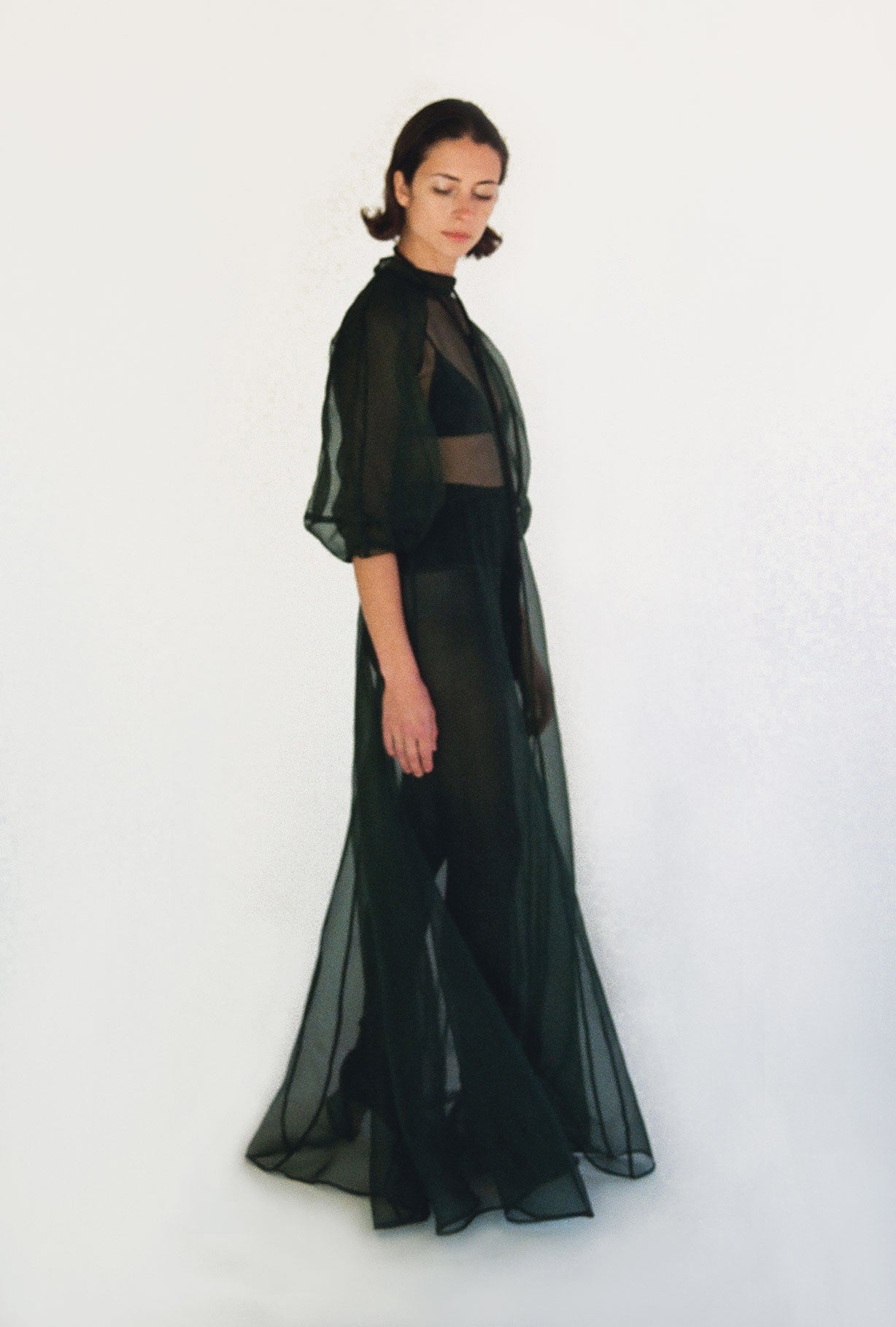 Back view of the dark green silk organza Kamperett Meiere Gown with mock neck and back button closure.