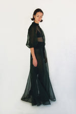 Back view of the dark green silk organza Kamperett Meiere Gown with mock neck and back button closure.