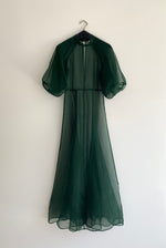 Editorial image of the dark green silk organza Kamperett Meiere Gown.