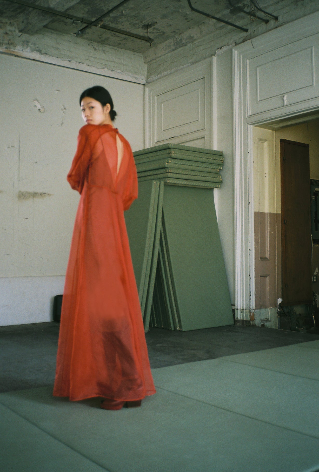 Editorial film image of the rust silk organza Kamperett Meiere Gown.