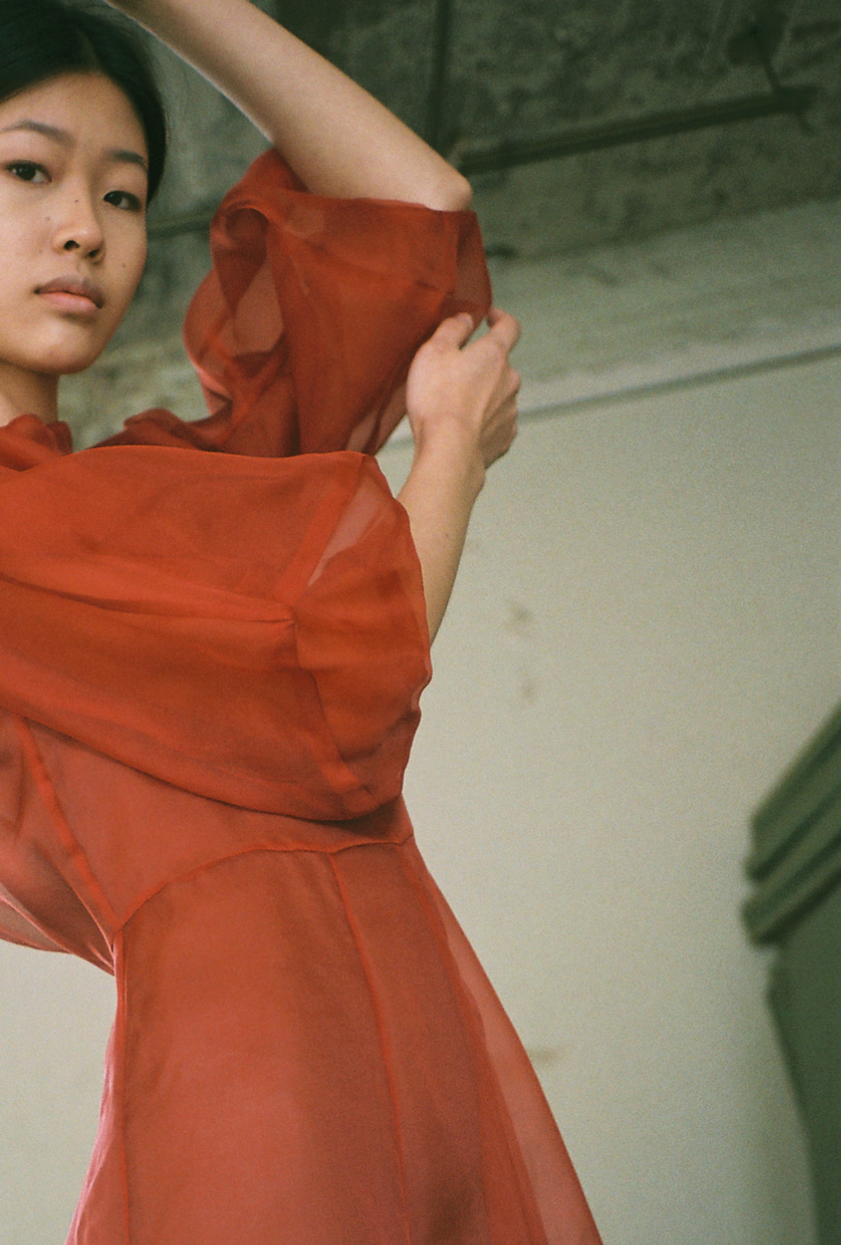 Editorial film image of the rust silk organza Kamperett Meiere Gown showing the sweeping skirt.