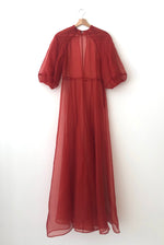Detail of the architectural cut-glass-inspired sleeves on the rust silk organza Kamperett Meiere Gown.