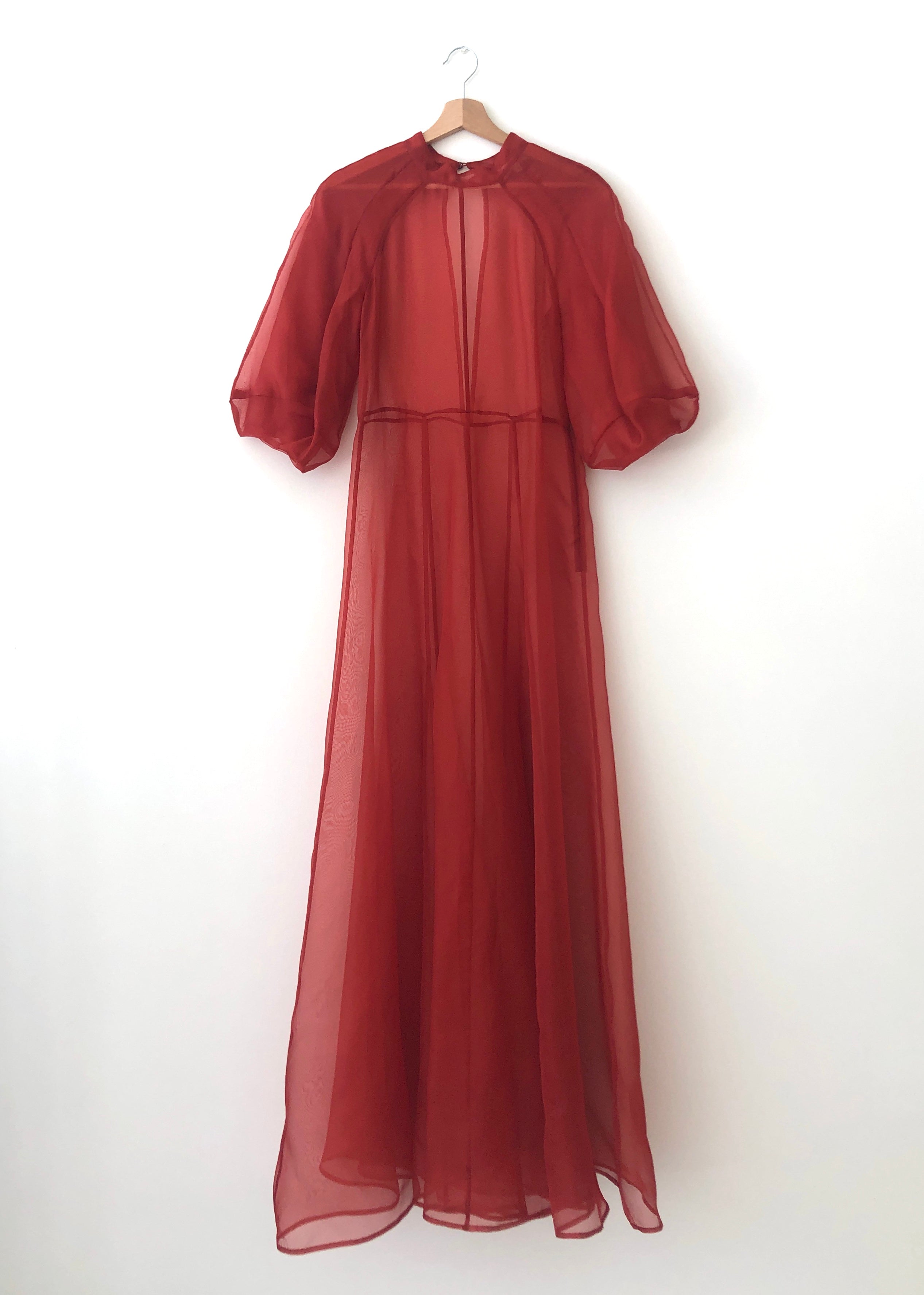 Detail of the architectural cut-glass-inspired sleeves on the rust silk organza Kamperett Meiere Gown.