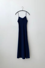 Front view of the navy silk charmeuse Kamperett Midi Slip, a bias-cut mid-calf slip with straight neckline.