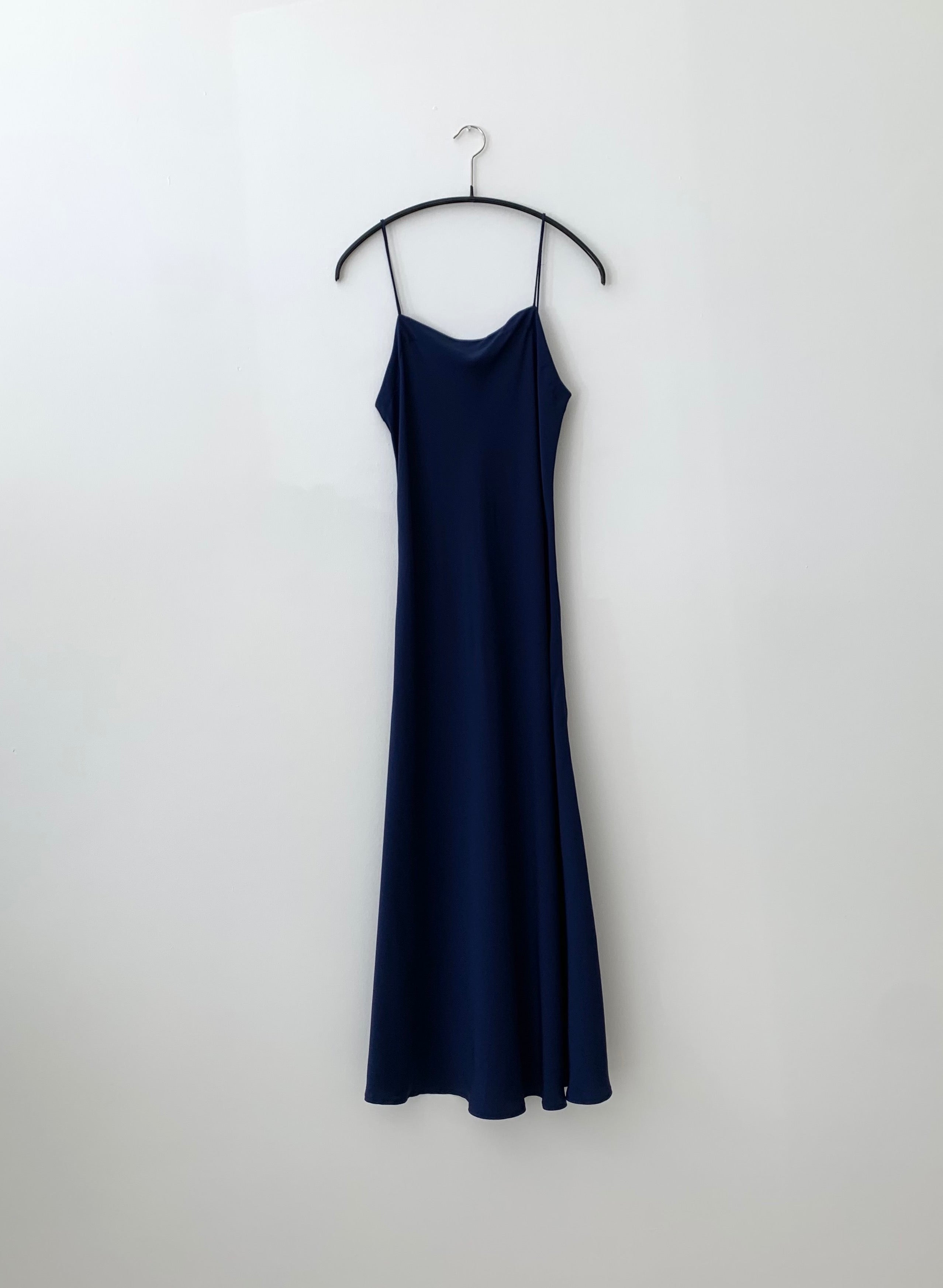 Front view of the navy silk charmeuse Kamperett Midi Slip, a bias-cut mid-calf slip with straight neckline.
