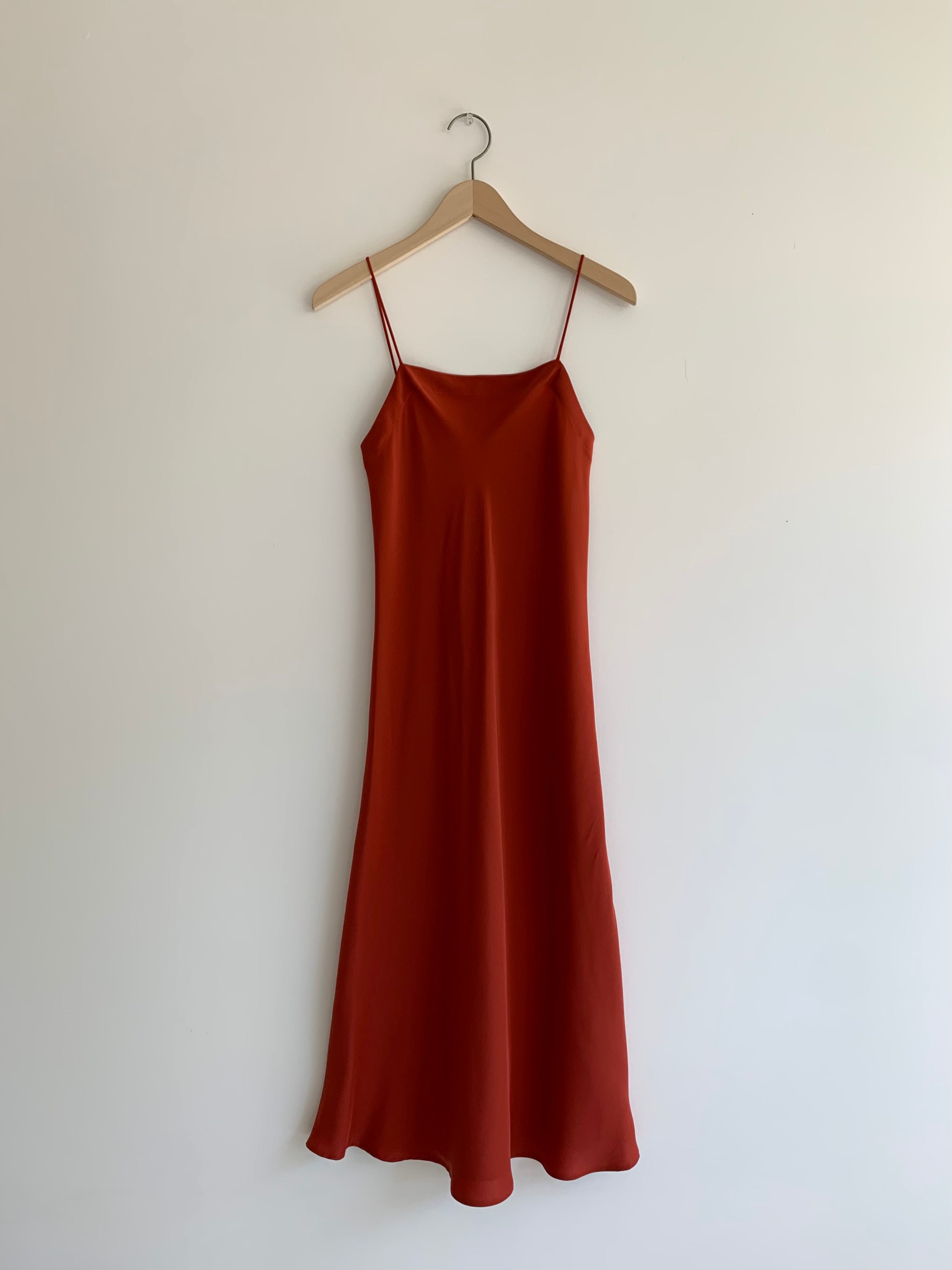 Front view of the rust sueded silk charmeuse Kamperett Midi Slip, a bias-cut mid-calf slip with straight neckline.