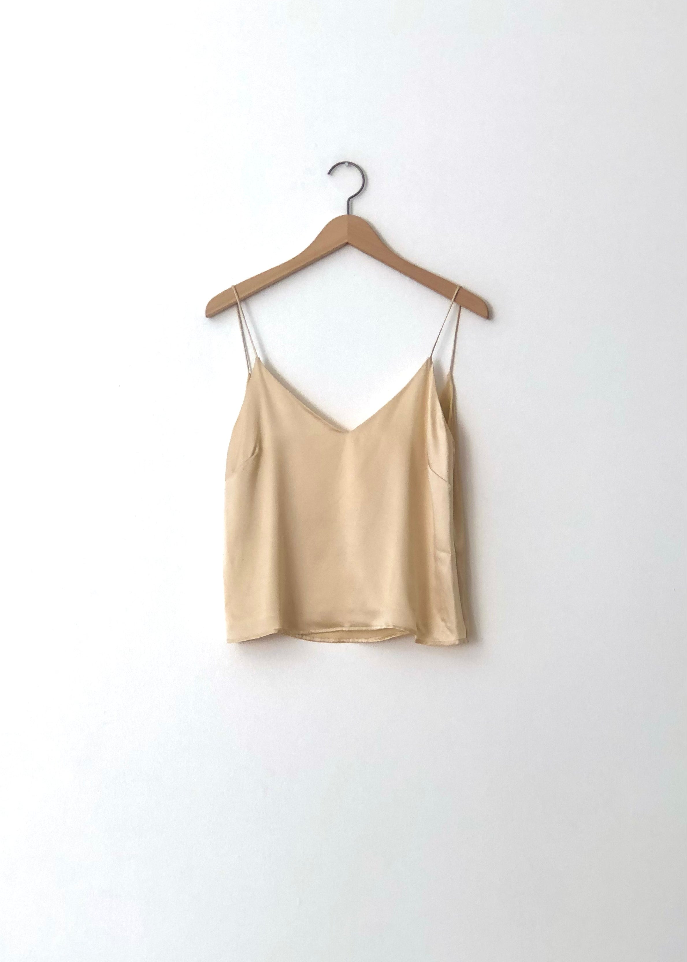 Detail of the boxy V-neck camisole on the champagne silk charmeuse Kamperett Sleep Set.