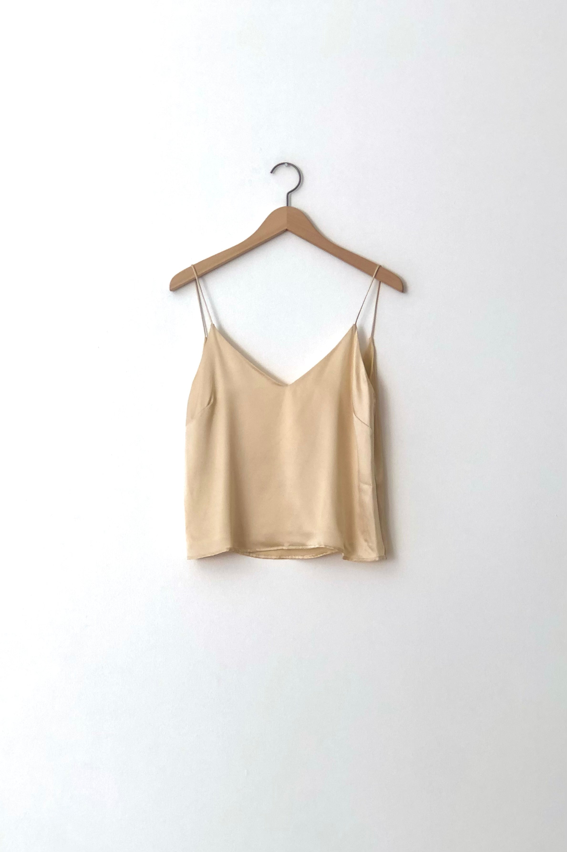 Detail of the boxy V-neck camisole on the champagne silk charmeuse Kamperett Sleep Set.