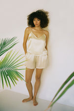 Side view of the champagne silk charmeuse Kamperett Sleep Set.