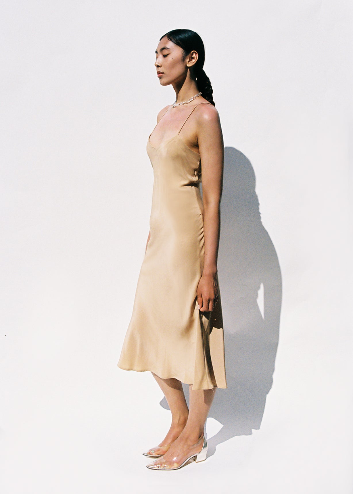 Editorial film image of the buff silk Kamperett V-Neck Midi Slip.