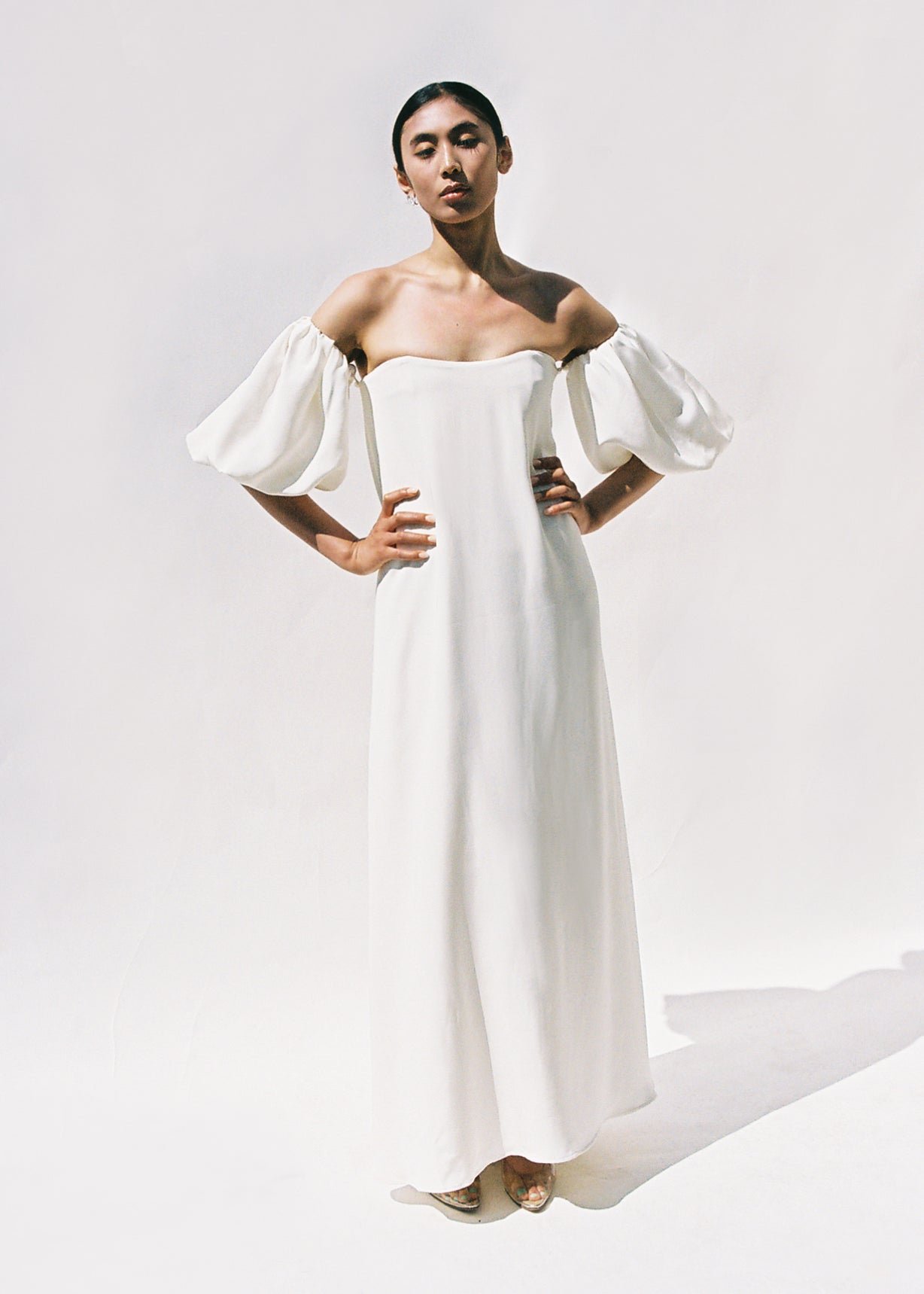 Editorial back view of the alabaster silk crepe Kamperett Verona Gown showing the subtle train.