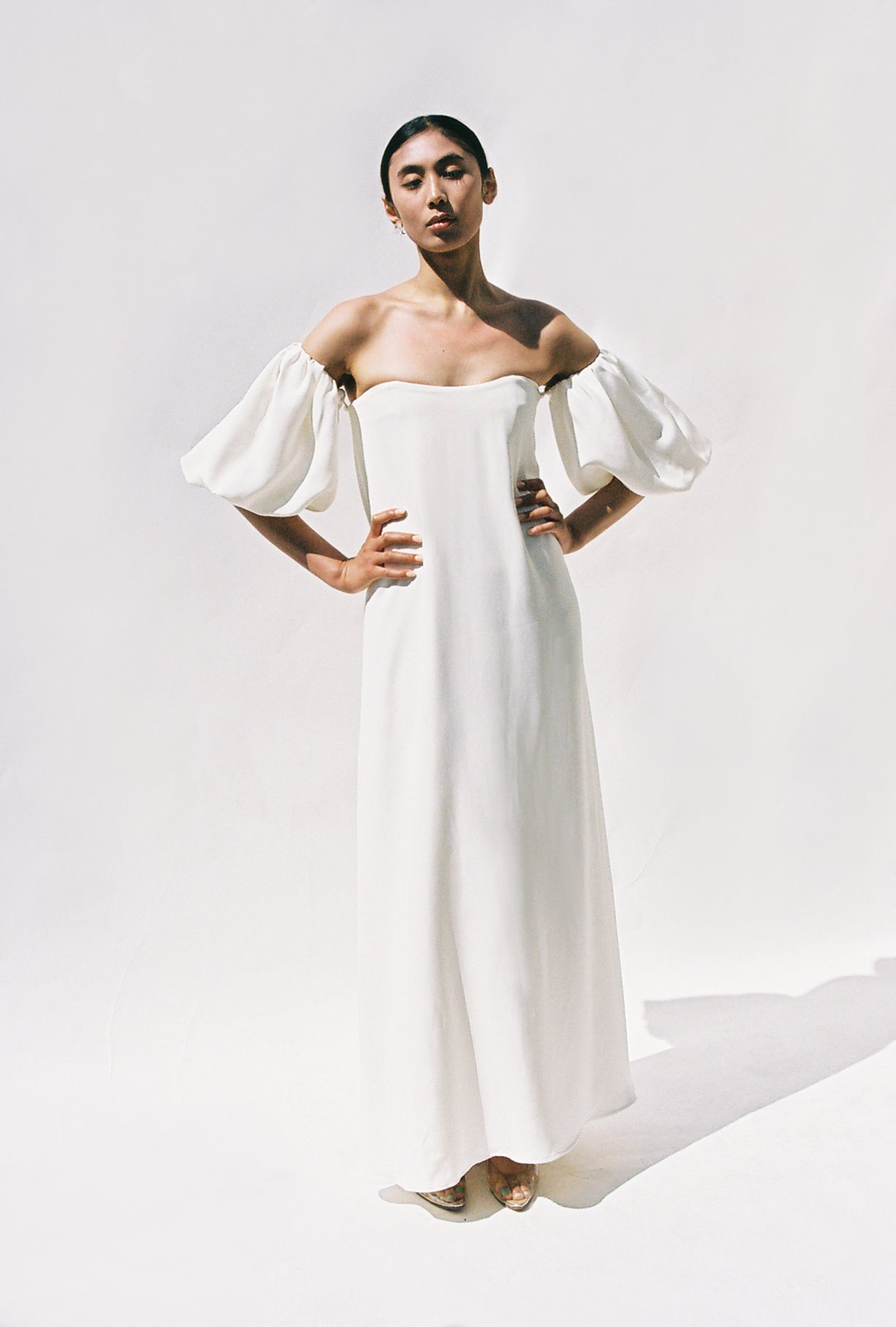 Editorial back view of the alabaster silk crepe Kamperett Verona Gown showing the subtle train.