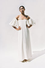 Editorial back view of the alabaster silk crepe Kamperett Verona Gown showing the subtle train.