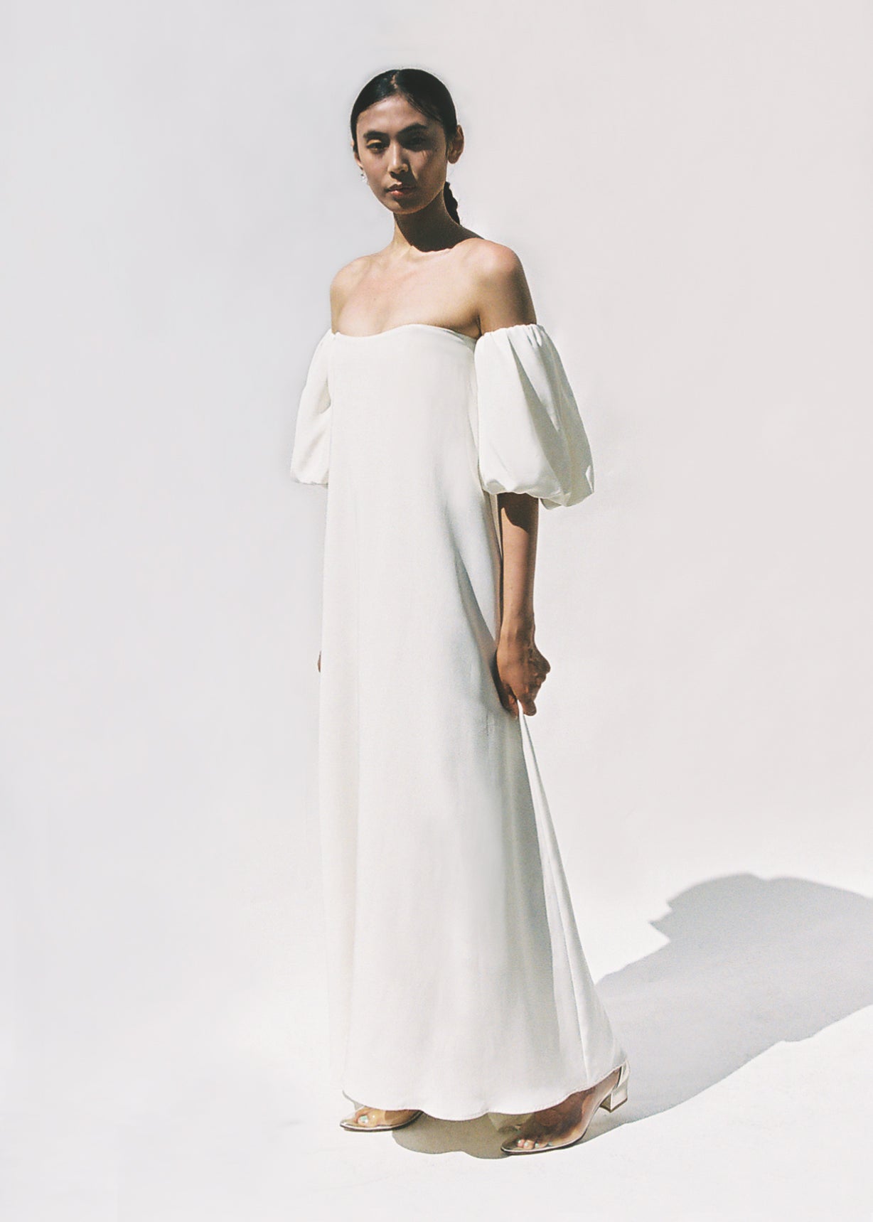 Editorial film image of the alabaster silk crepe Kamperett Verona Gown.