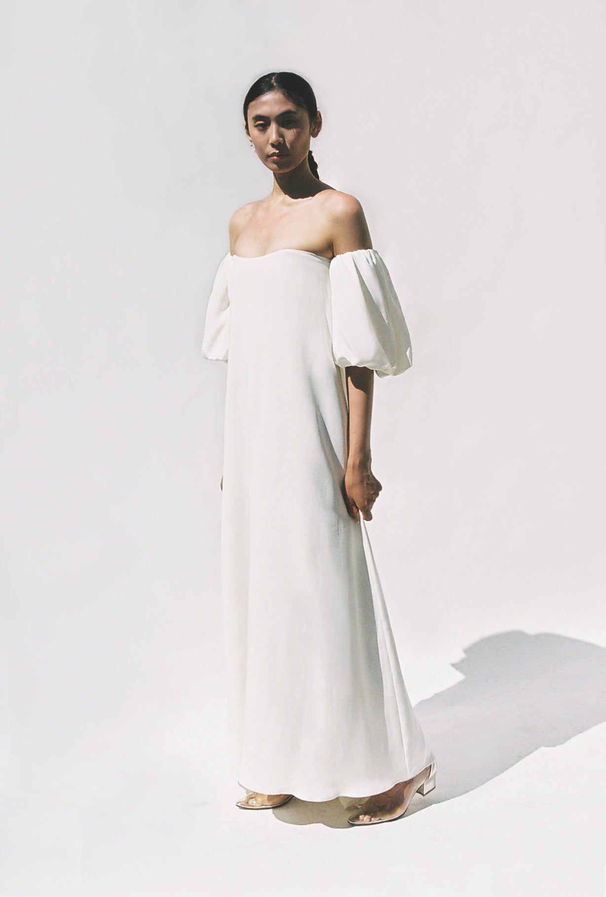 Editorial film image of the alabaster silk crepe Kamperett Verona Gown.