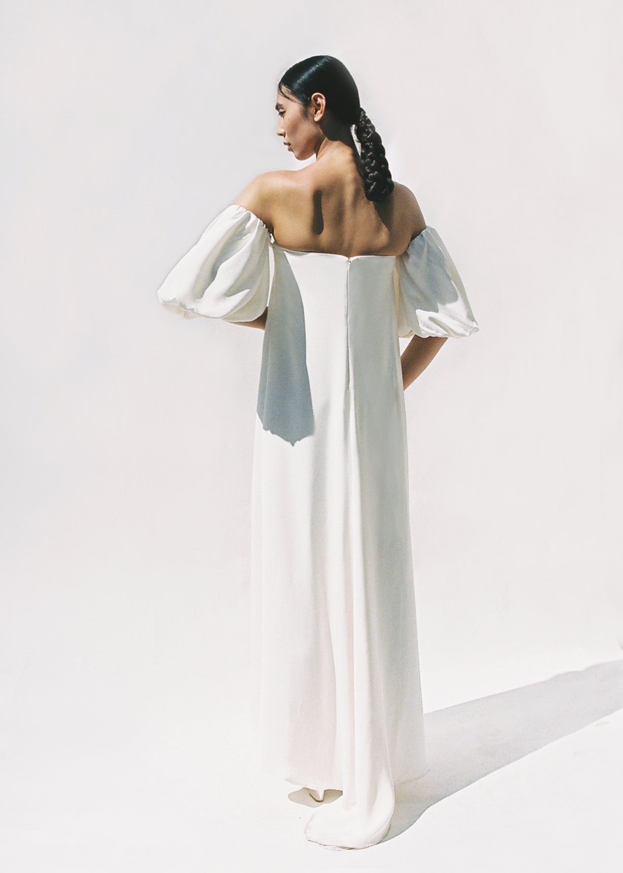 Editorial side view of the alabaster silk crepe Kamperett Verona Gown.