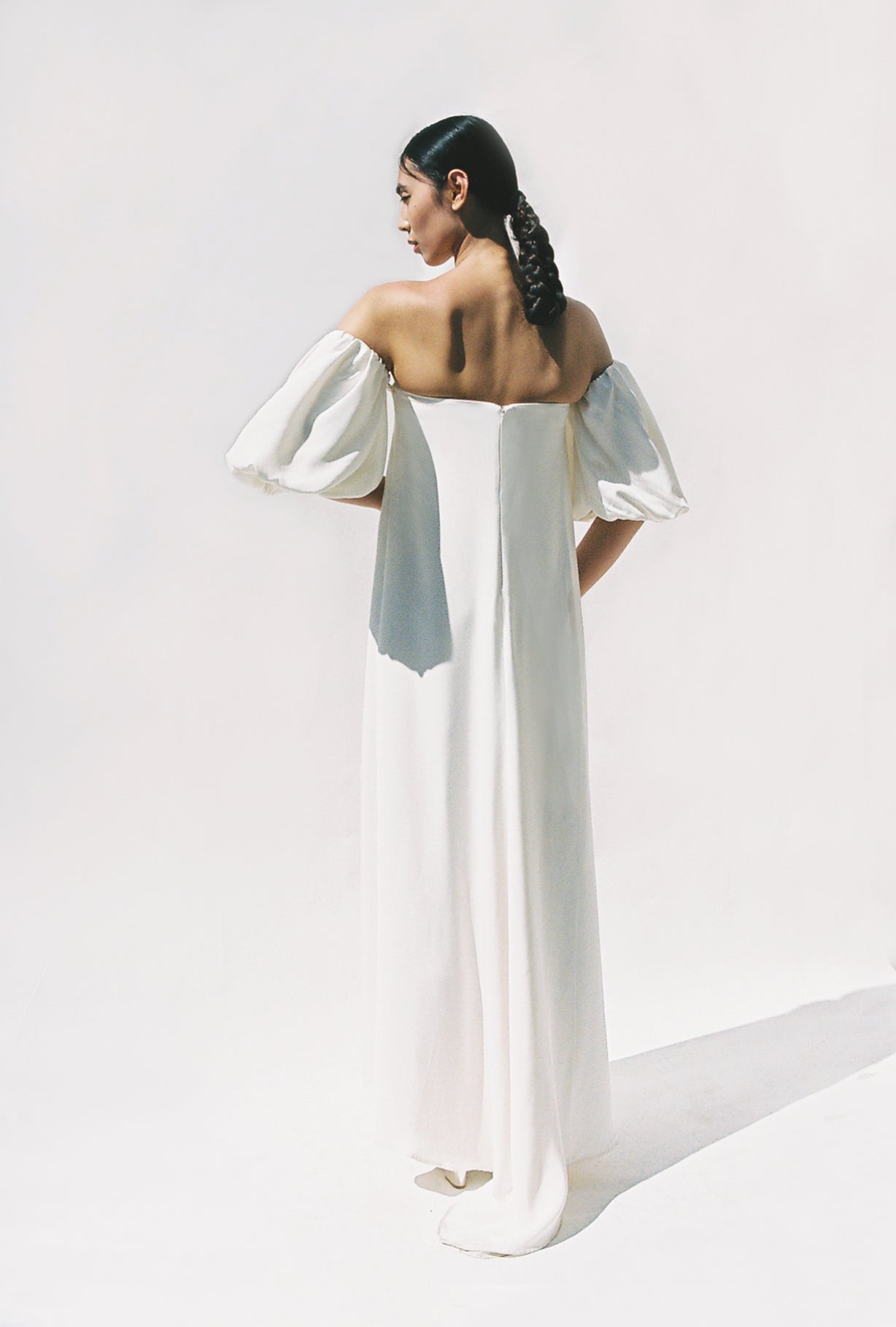 Editorial side view of the alabaster silk crepe Kamperett Verona Gown.