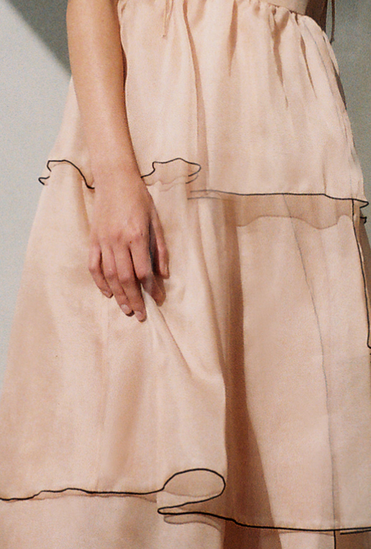 Back view of the blush silk organza Kamperett Laurence Midi Dress with corded straps tied at the shoulders.