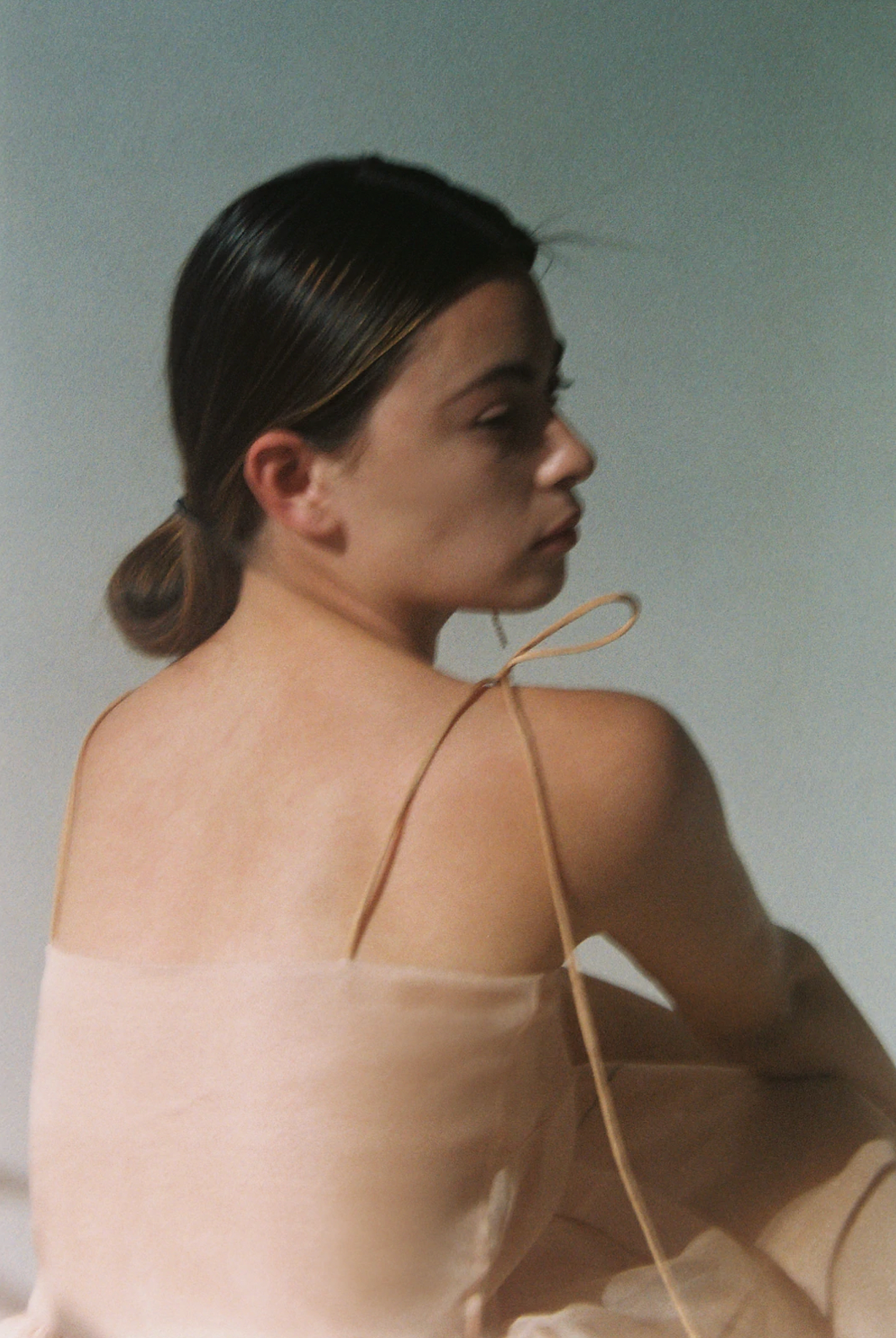 Close-up of the tiered silk organza panels and black pearl edge trim on the blush Kamperett Laurence Midi Dress.
